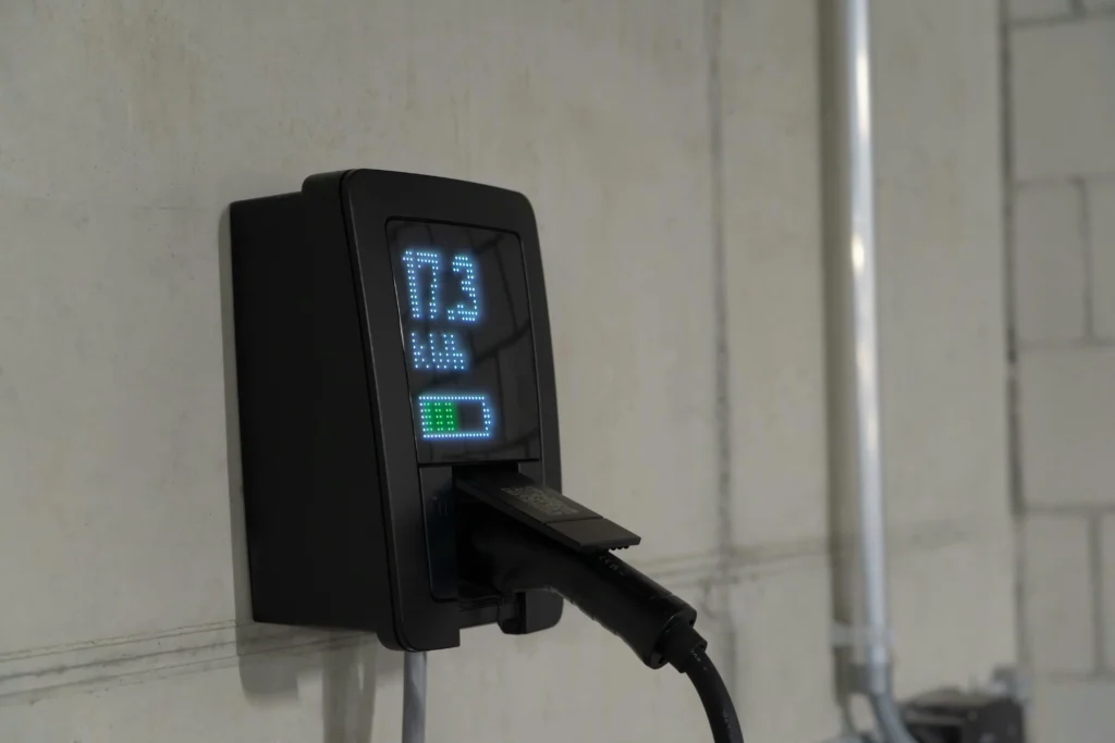 Wall-mounted Level 2 EV charger with digital display installed for home electric vehicle charging