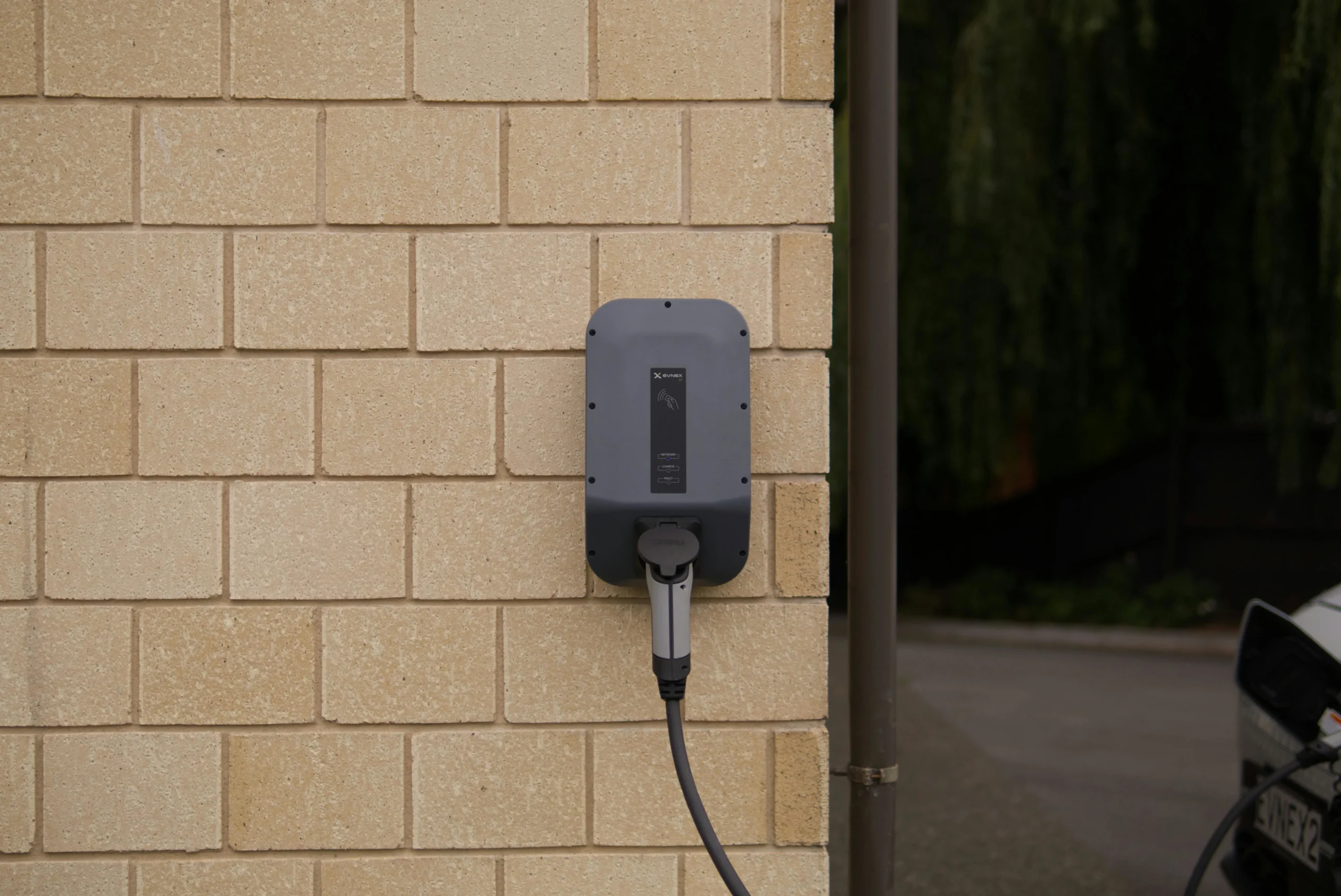 Wall-mounted Level 2 EV charger installed at home for electric vehicle charging