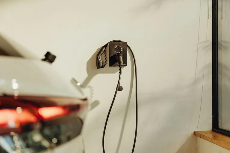 Wall-mounted Level 2 EV charger installed inside a residential garage