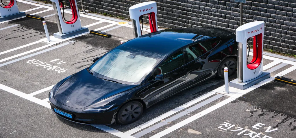 a Tesla plugged into an apartment supercharger