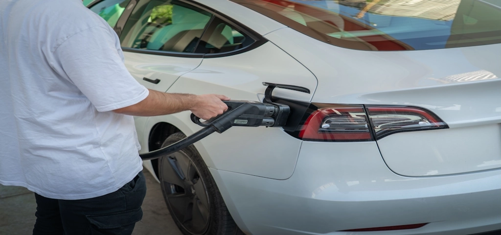 a man charging old EV using CCS charger